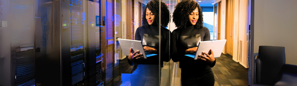 Lady standing and working on laptop