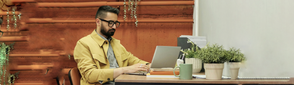 Man at table on computer