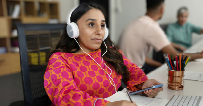 Woman with headphones on at desk