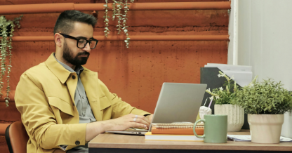 Man at table on computer